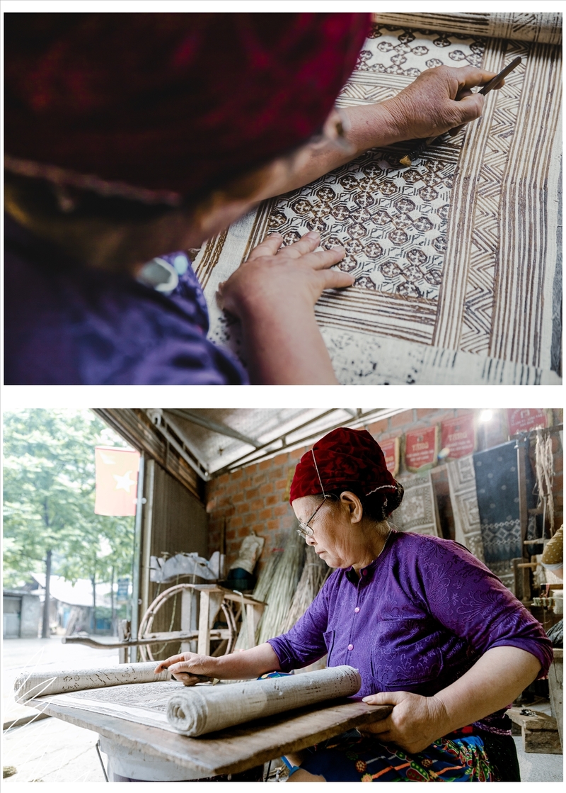 Thành viên dùng sáp ong được đun nóng để vẽ trên nền vải những họa tiết truyền thống của người Mông